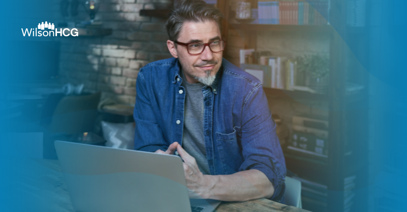 Mature business man using laptop in home office.