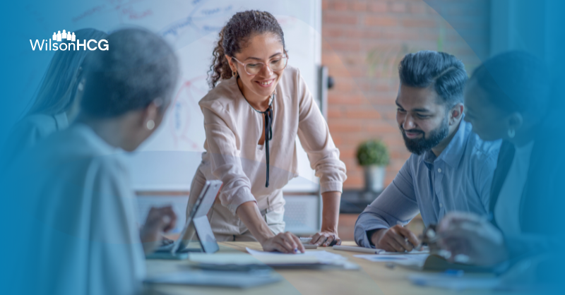 Hispanic woman leading a business meeting.