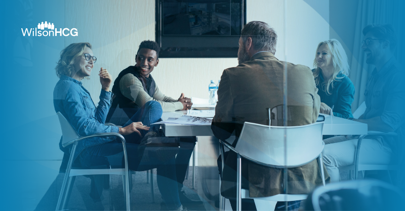 Diverse recruitment team meeting in a conference room.