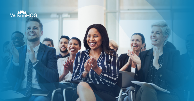 Diverse group of business professionals clapping.