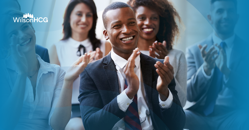 Diverse group of businesspersons applauding.