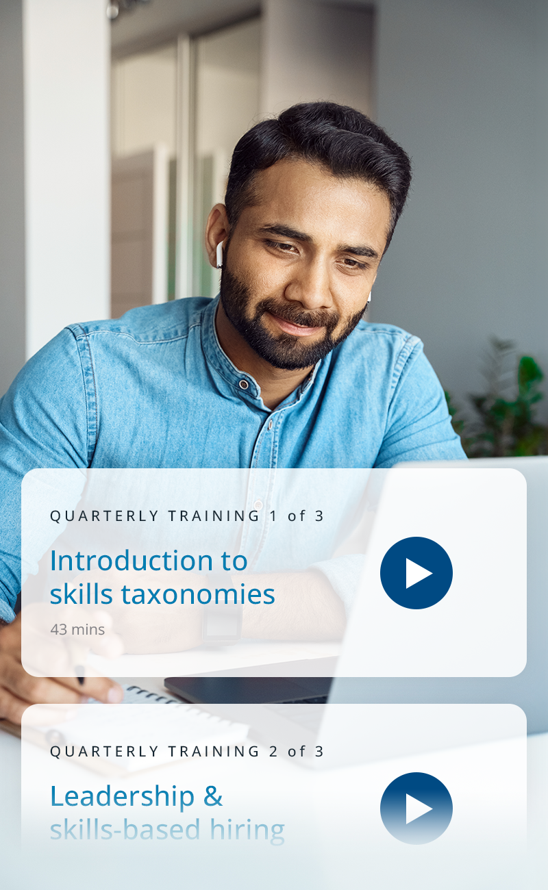 A man on his lapotop taking training courses for work about skills-based hiring and skills taxonomies