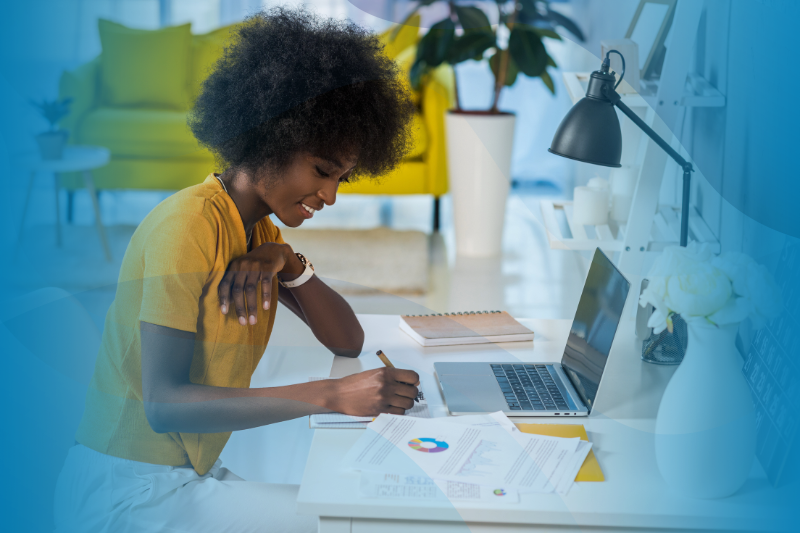 Side View of Smiling African American Female Working On Laptop